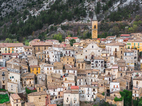Aerial view of the medieval village of Pacentro with its historic stone houses and prominent church tower nestled against the mountain slopes in Pacentro Abruzzo Italy. Aerial view of the medieval village of Pacentro with its historic stone houses and prominent church tower nestled against the mountain slopes in Pacentro Abruzzo Italy.
