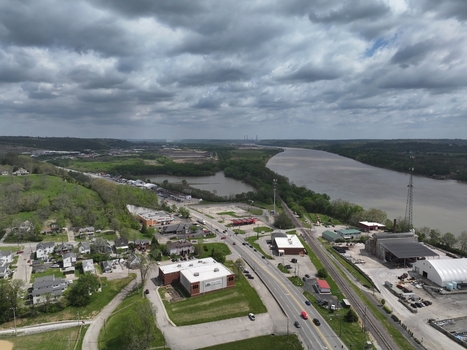 Aerial view of the town with the Ohio River industrial facilities residential houses and a railway line under a cloudy sky Aurora Indiana United States. Aerial view of the town with the Ohio River industrial facilities residential houses and a railway line under a cloudy sky Aurora Indiana United States.