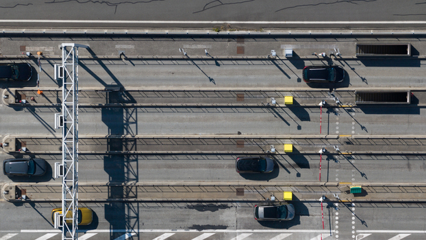 Aerial view of the Gare de Peage de Dury toll station with cars passing through lanes overhead gantries and road markings in Saleux Hauts de France France.