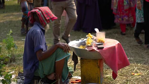 View of a street vendor selling yellow sweets in Bogura Bangladesh. View of a street vendor selling yellow sweets in Bogura Bangladesh.