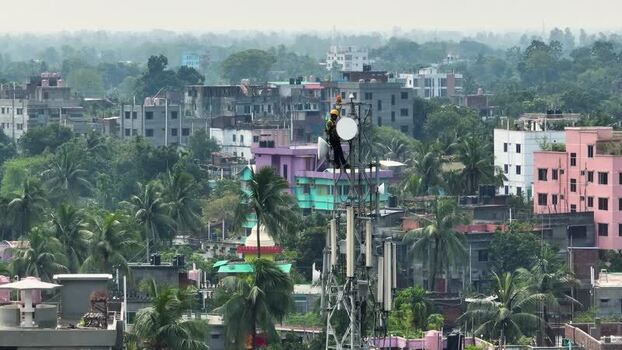 Aerial view of technicians on a cell tower in Rajshahi Bangladesh.