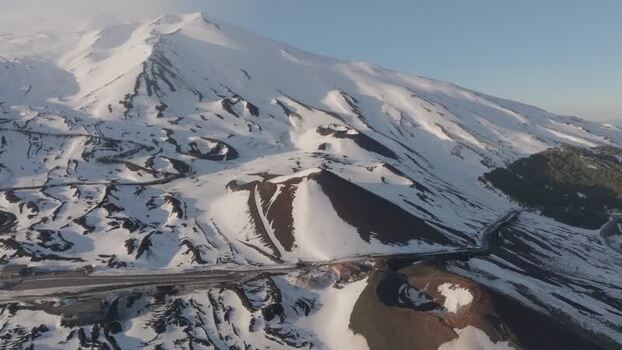 Aerial view of Rifugio Sapienza and snowy volcanic craters on Etna Italy. Aerial view of Rifugio Sapienza and snowy volcanic craters on Etna Italy.