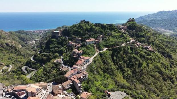 Aerial view of the hilltop village of Savoca and winding roads Italy. Aerial view of the hilltop village of Savoca and winding roads Italy.