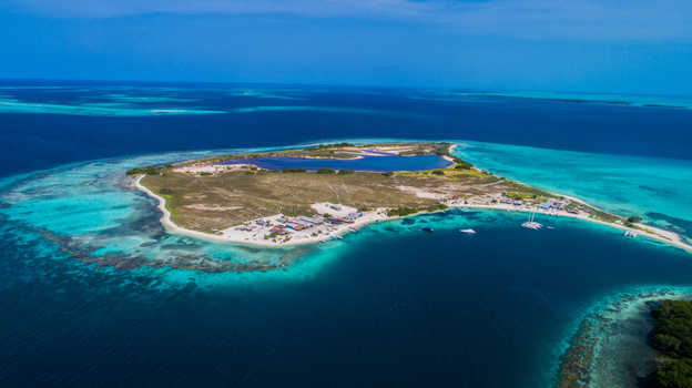 Aerial view of Los Roques archipelago with a central lagoon sandy beaches turquoise waters and boats anchored offshore in Los Roques Dependencias Federale Venezuela. Aerial view of Los Roques archipelago with a central lagoon sandy beaches turquoise waters and boats anchored offshore in Los Roques Dependencias Federale Venezuela.