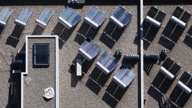 Aerial view of decentralized solar panels on roof Portugal.