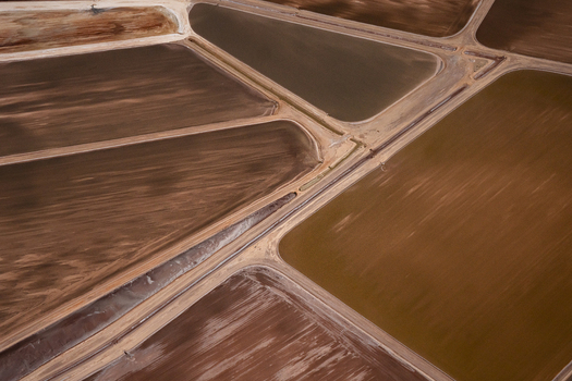 Aerial view of industrial salt evaporation ponds showing geometric patterns of brown and yellow earth textures in Kalbarri Western Australia Australia. Aerial view of industrial salt evaporation ponds showing geometric patterns of brown and yellow earth textures in Kalbarri Western Australia Australia.
