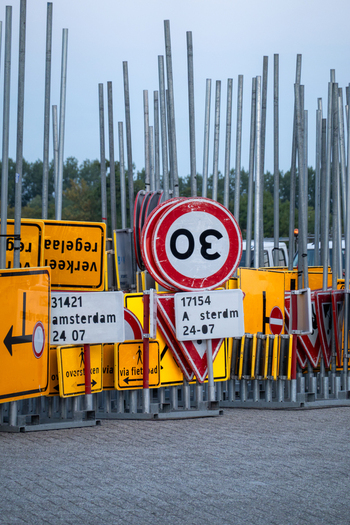 View of a traffic signs depot featuring various road signs including speed limit signs and directional signs mounted on metal poles in Zaandam North Holland Netherlands.