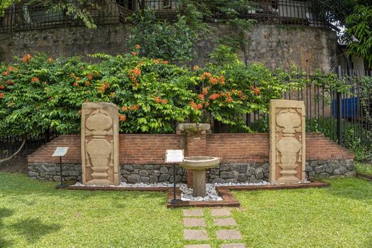 View of the historic stone fountain and carved pillars in the garden of the Sri Dalada Maligawa in Kandy Central Province Sri Lanka. View of the historic stone fountain and carved pillars in the garden of the Sri Dalada Maligawa in Kandy Central Province Sri Lanka.