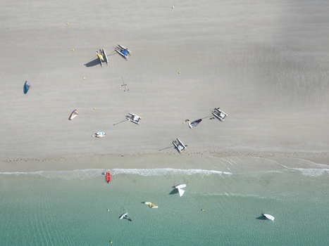 Aerial view of catamarans and sailboats on a sandy beach and in turquoise water Trebeurden Brittany France. Aerial view of catamarans and sailboats on a sandy beach and in turquoise water Trebeurden Brittany France.