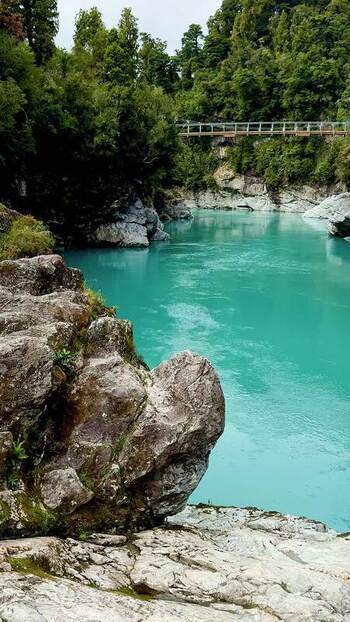 View of a turquoise river with rocky banks New Zealand. View of a turquoise river with rocky banks New Zealand.