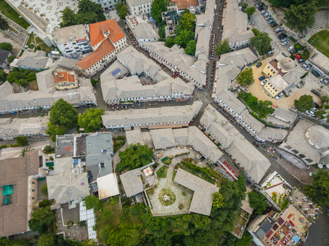 Aerial view of the historic old bazaar with traditional stone rooftops and narrow streets in Gjirokaster Gjirokaster County Albania. Aerial view of the historic old bazaar with traditional stone rooftops and narrow streets in Gjirokaster Gjirokaster County Albania.