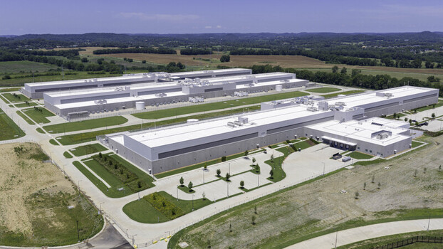 Aerial view of the Meta Data Center complex featuring large white industrial buildings parking areas and surrounding green fields in Gallatin Tennessee United States. Aerial view of the Meta Data Center complex featuring large white industrial buildings parking areas and surrounding green fields in Gallatin Tennessee United States.