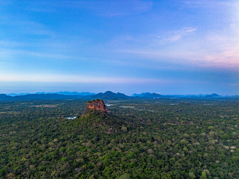 Aerial view of Sigiriya Lion Rock rising above the dense jungle canopy Sigiriya Central Province Sri Lanka. Aerial view of Sigiriya Lion Rock rising above the dense jungle canopy Sigiriya Central Province Sri Lanka.