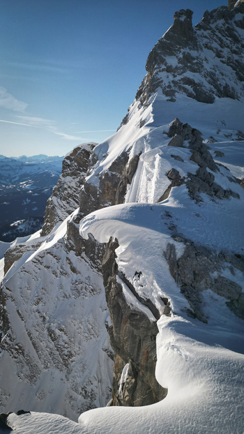 Aerial view of Pointe Percee with snow covered mountain ridges and sharp rocky peaks under a clear blue sky in Le Reposoir Auvergne Rhone Alpes France. Aerial view of Pointe Percee with snow covered mountain ridges and sharp rocky peaks under a clear blue sky in Le Reposoir Auvergne Rhone Alpes France.