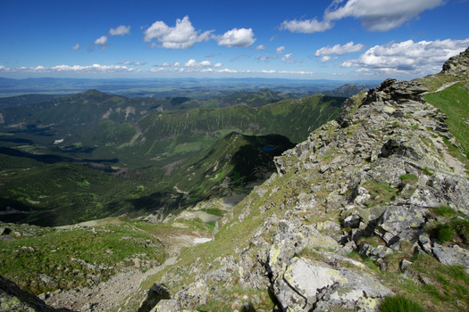 View of Tri kopy in Western Tatras with rocky mountain ridges and green alpine valleys under a blue sky with white clouds in Ziar Zilina Region Slovakia. View of Tri kopy in Western Tatras with rocky mountain ridges and green alpine valleys under a blue sky with white clouds in Ziar Zilina Region Slovakia.