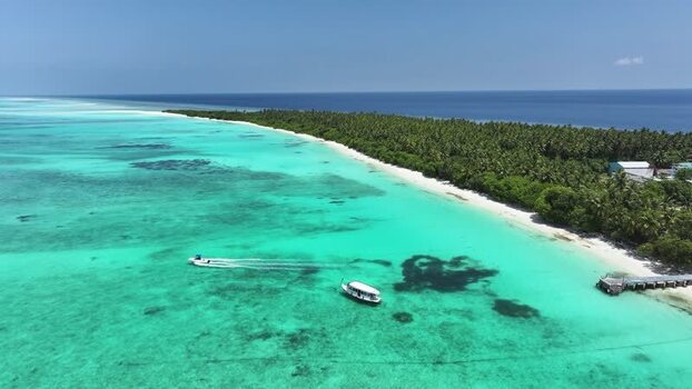 Aerial view of tropical island with boats and turquoise water Maldives. Aerial view of tropical island with boats and turquoise water Maldives.