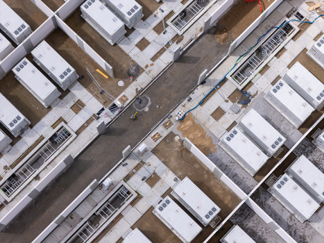 Aerial view of Zarnowiec BESS showing rows of white battery storage containers cooling units and concrete pathways in Wejherowo County Pomeranian Voivodeship Poland.