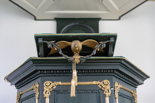 View of the historic pulpit with a golden eagle lectern and ornate gold decorations inside the Enskerk in Schokland Flevoland Netherlands.