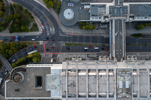 Aerial view of the ICC Berlin showcasing its iconic brutalist architecture adjacent multi lane roads with moving traffic and urban landscape in Berlin Berlin Germany. Aerial view of the ICC Berlin showcasing its iconic brutalist architecture adjacent multi lane roads with moving traffic and urban landscape in Berlin Berlin Germany.