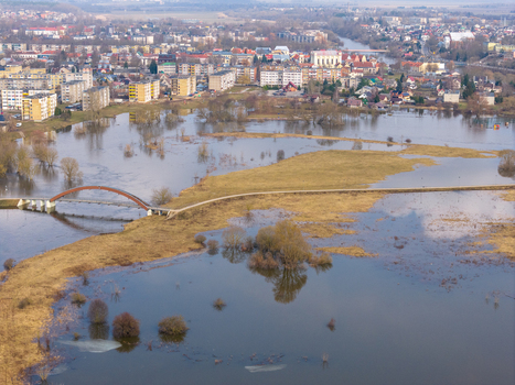 Aerial view of the flooded river valley with a pedestrian bridge and the town skyline in Kedainiai Kaunas County Lithuania. Aerial view of the flooded river valley with a pedestrian bridge and the town skyline in Kedainiai Kaunas County Lithuania.