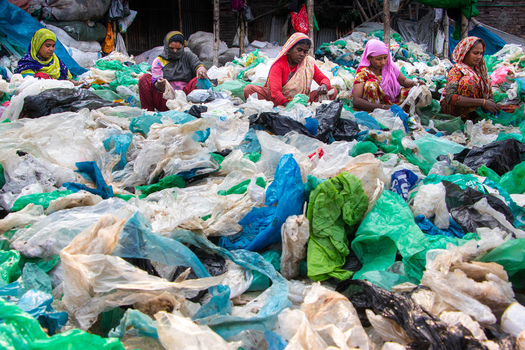 Keraniganj Bangladesh 05 February 2023 View of women sitting and sorting through a vast pile of colorful plastic waste and bags at a recycling facility. Keraniganj Bangladesh 05 February 2023 View of women sitting and sorting through a vast pile of colorful plastic waste and bags at a recycling facility.