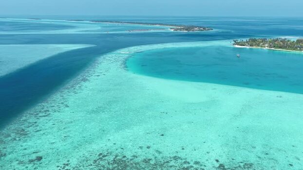 Aerial view of tropical islands and coral reefs in Maldives. Aerial view of tropical islands and coral reefs in Maldives.