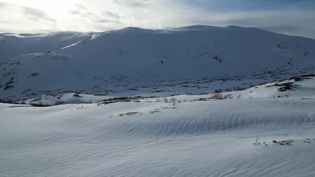 Aerial view of snow covered mountains on Kvaloya island Norway.