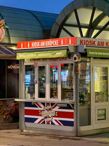 Hanover Lower Saxony Germany 30 March 2026 View of the Kiosk am Kropcke a small retail structure with a British flag design and illuminated signage in the city center.