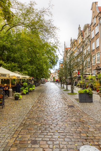 Gdansk Pomeranian Voivodeship Poland 05 September 2026 View of a cobblestone street in the historic city center with outdoor restaurant seating and traditional architecture. Gdansk Pomeranian Voivodeship Poland 05 September 2026 View of a cobblestone street in the historic city center with outdoor restaurant seating and traditional architecture.