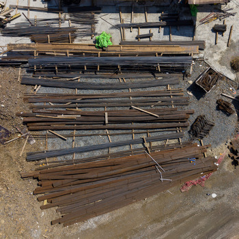 Aerial view of organized stacks of rusty and dark steel rebar stored on a gravel construction site in Istanbul Istanbul Turkiye. Aerial view of organized stacks of rusty and dark steel rebar stored on a gravel construction site in Istanbul Istanbul Turkiye.