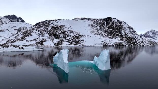Aerial view of an iceberg floating in a fjord Greenland. Aerial view of an iceberg floating in a fjord Greenland.