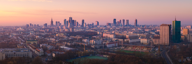 Warsaw Poland 08 March 2025 Aerial view of the Warsaw skyline at sunset featuring modern skyscrapers urban architecture and a stadium in the foreground under a warm sky. Warsaw Poland 08 March 2025 Aerial view of the Warsaw skyline at sunset featuring modern skyscrapers urban architecture and a stadium in the foreground under a warm sky.
