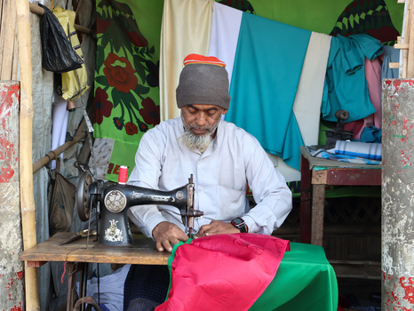 Cox s Bazar Chittagong Division Bangladesh 19 July 2026 View of a tailor working at a vintage manual sewing machine inside a makeshift shelter at the Rohingya refugee camp. Cox s Bazar Chittagong Division Bangladesh 19 July 2026 View of a tailor working at a vintage manual sewing machine inside a makeshift shelter at the Rohingya refugee camp.