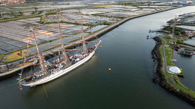 Aerial view of the tall ship NRP Sagres decorated with signal flags navigating the Canal de Aveiro near the salt pans Aveiro Aveiro Portugal. Aerial view of the tall ship NRP Sagres decorated with signal flags navigating the Canal de Aveiro near the salt pans Aveiro Aveiro Portugal.