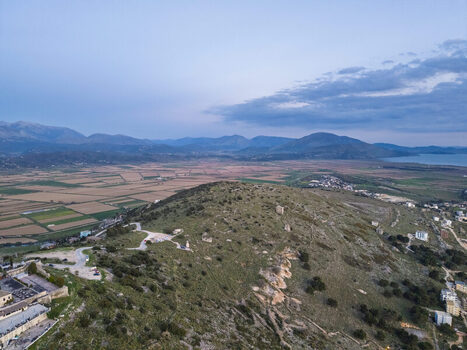 Aerial view of rolling hills and agricultural fields near Saranda featuring rocky terrain scattered vegetation and distant mountains in Saranda Vlore County Albania. Aerial view of rolling hills and agricultural fields near Saranda featuring rocky terrain scattered vegetation and distant mountains in Saranda Vlore County Albania.