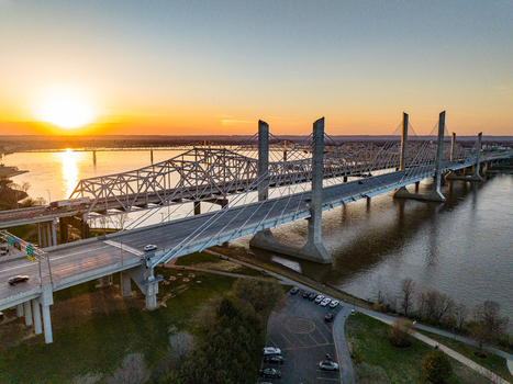 Aerial view of the Abraham Lincoln Bridge spanning the Ohio River during a golden sunset Louisville Kentucky United States. Aerial view of the Abraham Lincoln Bridge spanning the Ohio River during a golden sunset Louisville Kentucky United States.
