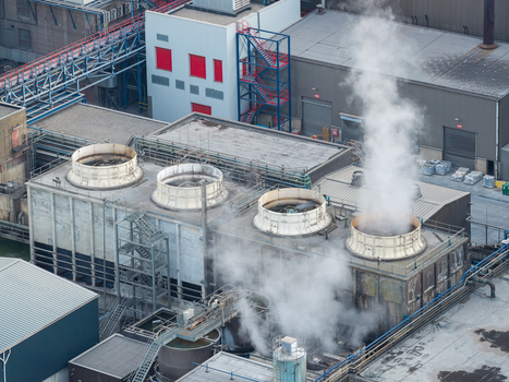 Aerial view of the industrial facility at Haven Genk with cooling towers and steam emissions in Genk Vlaanderen Belgium.