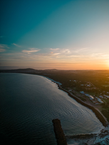 Aerial view of the Emu Point coastline at sunset with calm waters sandy beach and coastal vegetation Emu Point Western Australia Australia. Aerial view of the Emu Point coastline at sunset with calm waters sandy beach and coastal vegetation Emu Point Western Australia Australia.