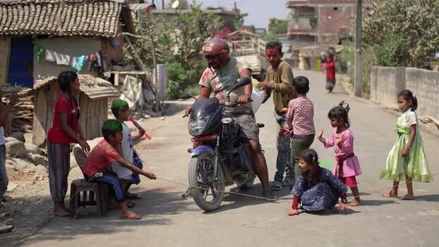 View of people celebrating Holi festival on a street in Dang Nepal.
