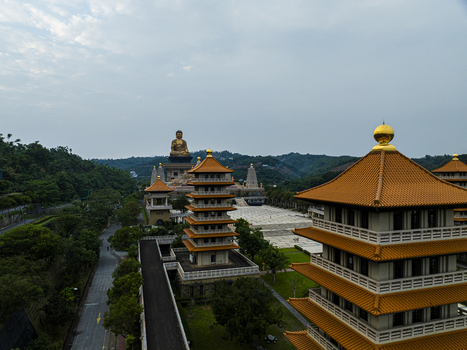 Aerial view of the Fo Guang Shan Buddha Museum featuring a golden Buddha statue traditional pagodas with orange roofs and courtyards in Jiuru Township Pingtung County Taiwan. Aerial view of the Fo Guang Shan Buddha Museum featuring a golden Buddha statue traditional pagodas with orange roofs and courtyards in Jiuru Township Pingtung County Taiwan.