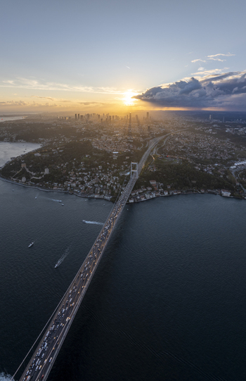Aerial view of Fatih Sultan Mehmet Bridge spanning the Bosphorus at sunset with golden light reflecting on the water and city skyline in Beykoz Istanbul Turkiye. Aerial view of Fatih Sultan Mehmet Bridge spanning the Bosphorus at sunset with golden light reflecting on the water and city skyline in Beykoz Istanbul Turkiye.