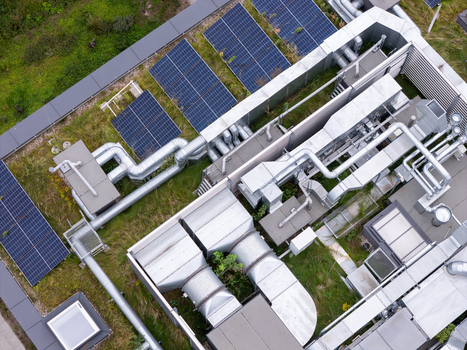 Aerial view of a green roof featuring solar panels and industrial HVAC ventilation systems in Gdansk Poland. Aerial view of a green roof featuring solar panels and industrial HVAC ventilation systems in Gdansk Poland.