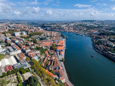 Aerial view of Jardins do Palacio de Cristal overlooking the Douro River and the historic cityscape of Porto with terracotta rooftops in Porto Porto Portugal. Aerial view of Jardins do Palacio de Cristal overlooking the Douro River and the historic cityscape of Porto with terracotta rooftops in Porto Porto Portugal.