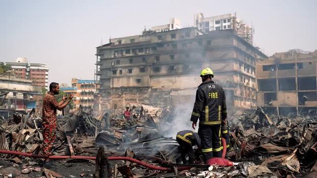 View of firefighters at a fire scene among debris Bangladesh. View of firefighters at a fire scene among debris Bangladesh.