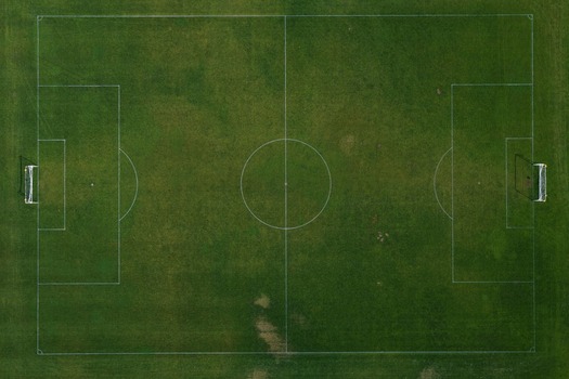 Aerial view of a green soccer field with white markings and goalposts in Boulder Colorado United States. Aerial view of a green soccer field with white markings and goalposts in Boulder Colorado United States.
