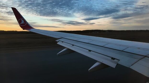 View of Turkish Airlines wing at sunset in Finland.