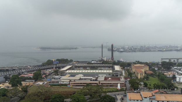 Aerial view of Lagos Island featuring the stadium surrounding urban infrastructure and the harbor under a cloudy sky in Lagos Lagos Nigeria. Aerial view of Lagos Island featuring the stadium surrounding urban infrastructure and the harbor under a cloudy sky in Lagos Lagos Nigeria.