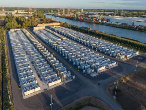 Aerial view of the Cargovil battery energy storage system featuring rows of industrial battery containers situated near a canal and logistics warehouses in Vilvoorde Vlaanderen Belgium. Aerial view of the Cargovil battery energy storage system featuring rows of industrial battery containers situated near a canal and logistics warehouses in Vilvoorde Vlaanderen Belgium.