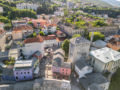 Mostar Bosnia and Herzegovina 28 May 2025 Aerial view of the historic Old Bridge Mostar surrounded by stone buildings narrow streets and lush greenery. Mostar Bosnia and Herzegovina 28 May 2025 Aerial view of the historic Old Bridge Mostar surrounded by stone buildings narrow streets and lush greenery.