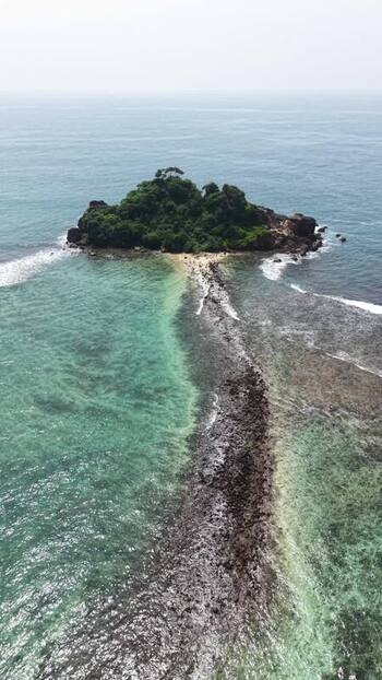 Aerial view of Devil s Rock island and turquoise sea Sri Lanka.